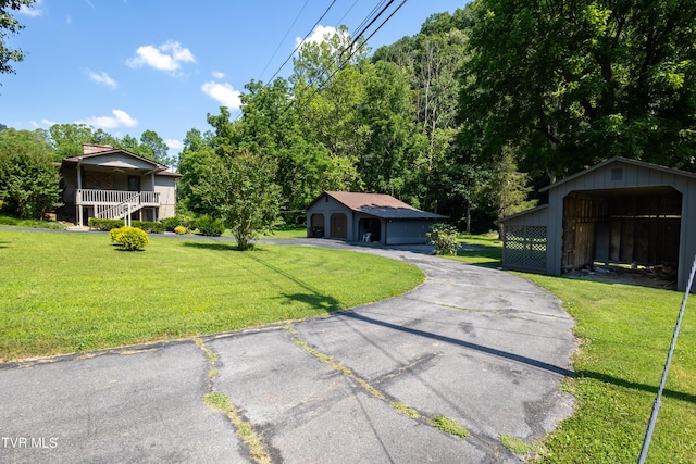 1605 Ryder Church Rd, Bluff City, TN 37618 - view of front of house featuring an outbuilding, a front lawn, and asphalt driveway