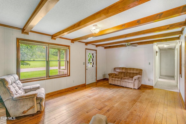 1605 Ryder Church Rd, Bluff City, TN 37618 - living room featuring beam ceiling, light wood-type flooring, a textured ceiling, and ceiling fan