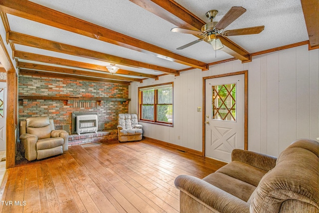 1605 Ryder Church Rd, Bluff City, TN 37618 - living area featuring heating unit, beam ceiling, hardwood / wood-style floors, ceiling fan, and a textured ceiling
