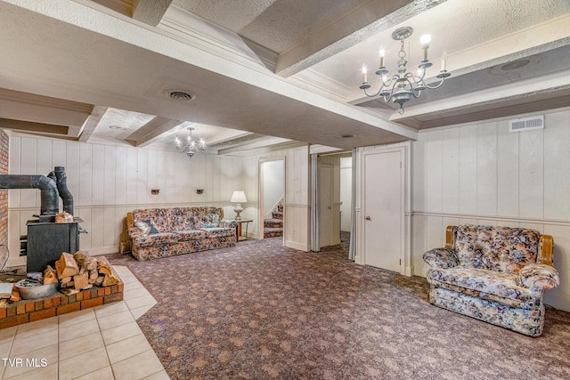 1605 Ryder Church Rd, Bluff City, TN 37618 - living area featuring a chandelier, a wood stove, beamed ceiling, stairs, and wood walls