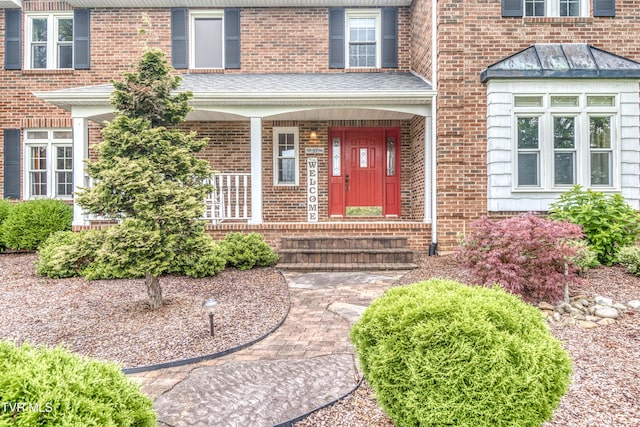 22319 Campground Rd, Bristol, VA 24202 - doorway to property featuring brick siding, covered porch, and a standing seam roof