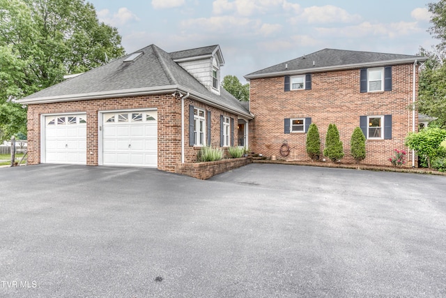 22319 Campground Rd, Bristol, VA 24202 - view of front facade with driveway, brick siding, an attached garage, and roof with shingles
