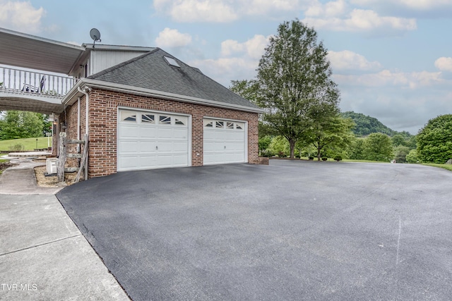 22319 Campground Rd, Bristol, VA 24202 - view of side of home with brick siding, driveway, roof with shingles, a balcony, and an attached garage