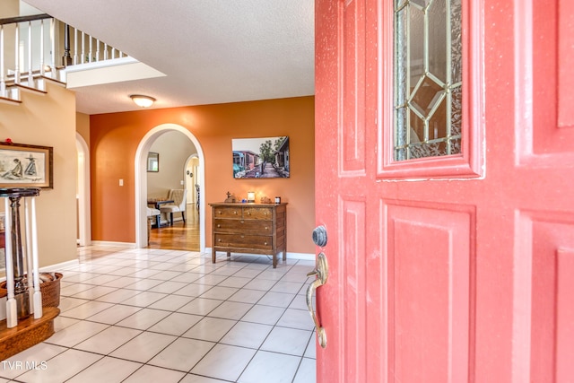 22319 Campground Rd, Bristol, VA 24202 - entryway with arched walkways, light tile patterned floors, a textured ceiling, and baseboards