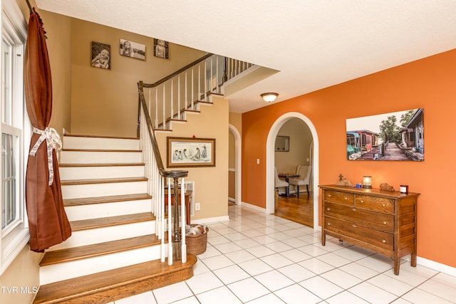22319 Campground Rd, Bristol, VA 24202 - stairway with arched walkways, tile patterned floors, and baseboards