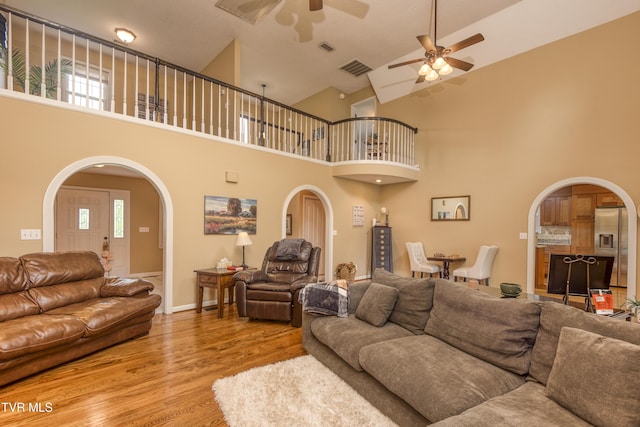 22319 Campground Rd, Bristol, VA 24202 - living room with arched walkways, ceiling fan, wood finished floors, and high vaulted ceiling
