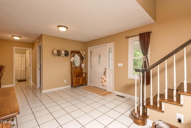 22319 Campground Rd, Bristol, VA 24202 - entryway featuring baseboards, stairs, light tile patterned floors, and a textured ceiling