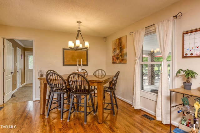 22319 Campground Rd, Bristol, VA 24202 - dining room with a chandelier, baseboards, wood finished floors, and a textured ceiling