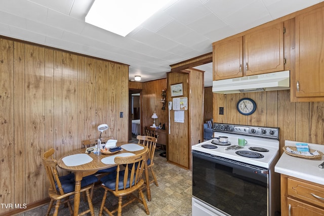 1730 Baileyton Main St, Greeneville, TN 37745 - kitchen with white range with electric cooktop, under cabinet range hood, wooden walls, brown cabinetry, and light countertops