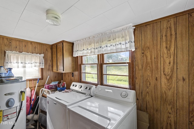 1730 Baileyton Main St, Greeneville, TN 37745 - washroom with electric water heater, washing machine and dryer, cabinet space, and wood walls