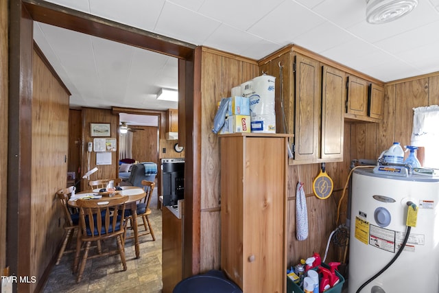 1730 Baileyton Main St, Greeneville, TN 37745 - kitchen featuring water heater, wood walls, and brown cabinets