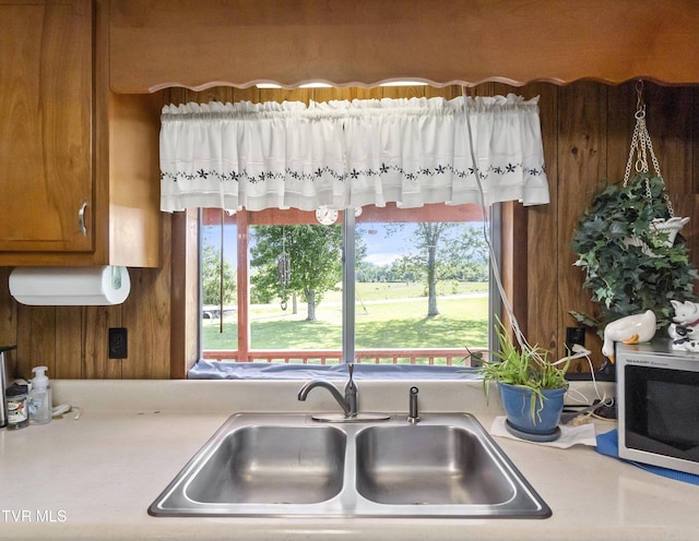 1730 Baileyton Main St, Greeneville, TN 37745 - kitchen with white microwave, a sink, light countertops, and brown cabinetry