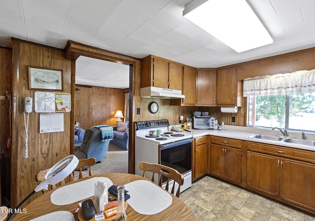 1730 Baileyton Main St, Greeneville, TN 37745 - kitchen featuring white electric range oven, wood walls, under cabinet range hood, a sink, and light countertops