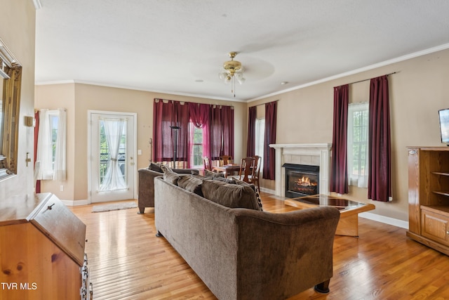 1402 Lake Ridge Sq, Johnson City, TN 37601 - living room featuring a ceiling fan, light wood finished floors, baseboards, a tile fireplace, and ornamental molding