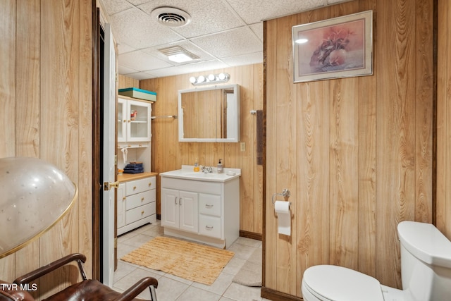 1402 Lake Ridge Sq, Johnson City, TN 37601 - bathroom with toilet, vanity, wood walls, tile patterned flooring, and a drop ceiling