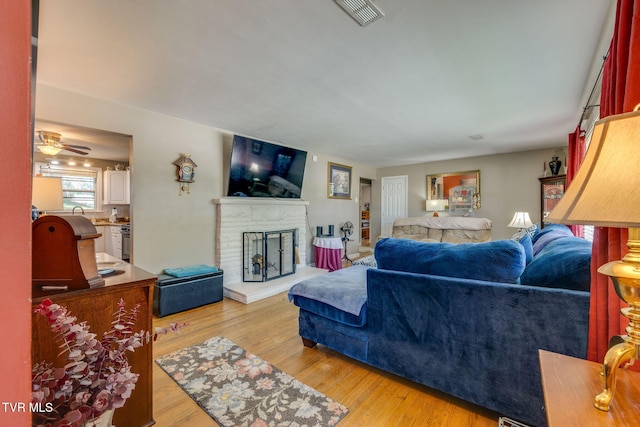 2228 Bruce St, Kingsport, TN 37664 - living room featuring wood finished floors, a fireplace, and a ceiling fan