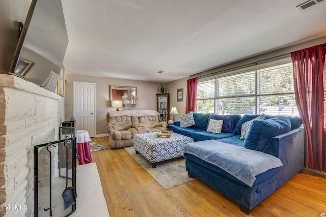 2228 Bruce St, Kingsport, TN 37664 - living room featuring wood finished floors, a fireplace, and baseboards