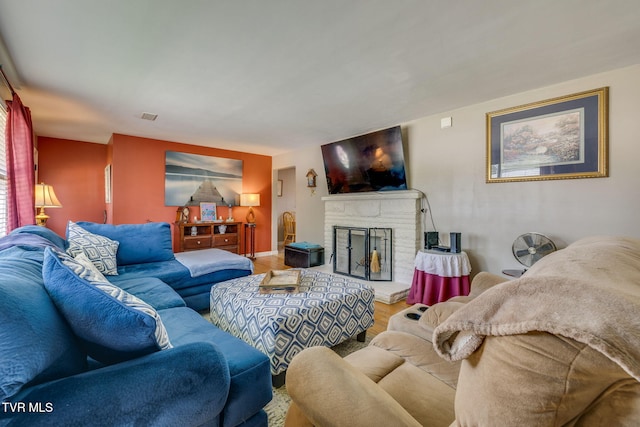 2228 Bruce St, Kingsport, TN 37664 - living room with wood finished floors, a brick fireplace, and baseboards