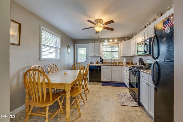 2228 Bruce St, Kingsport, TN 37664 - kitchen featuring black appliances, healthy amount of natural light, white cabinets, and a ceiling fan