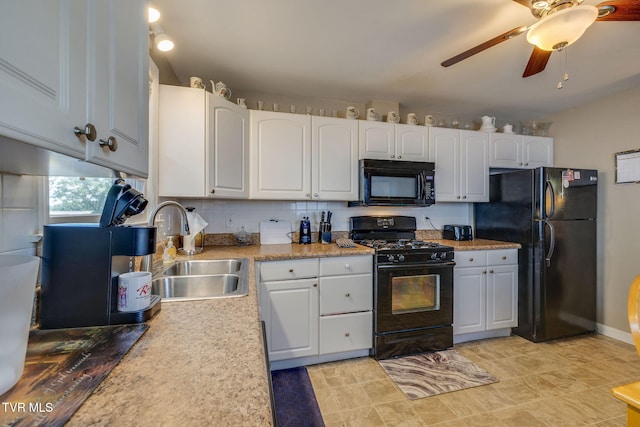2228 Bruce St, Kingsport, TN 37664 - kitchen with black appliances, a sink, white cabinetry, and light countertops