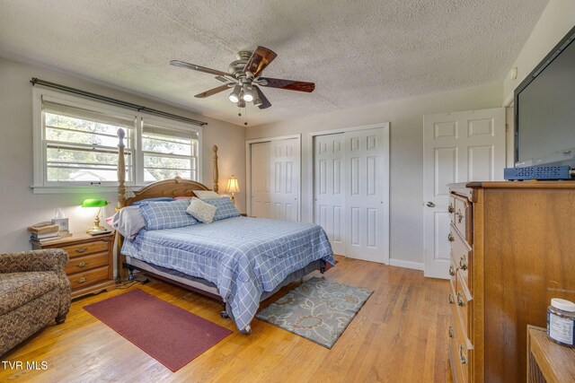 2228 Bruce St, Kingsport, TN 37664 - bedroom with multiple closets, a textured ceiling, light wood-type flooring, a ceiling fan, and baseboards