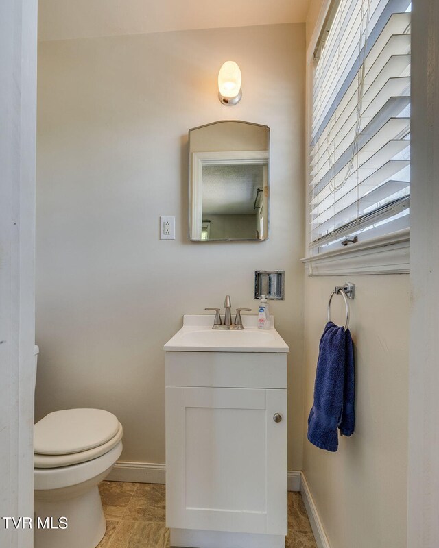 2228 Bruce St, Kingsport, TN 37664 - bathroom featuring vanity, toilet, and baseboards