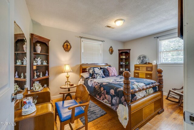 2228 Bruce St, Kingsport, TN 37664 - bedroom with wood finished floors, a textured ceiling, and baseboards