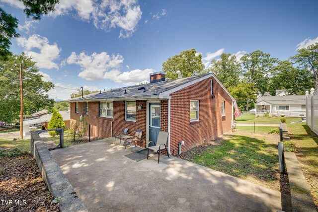 2228 Bruce St, Kingsport, TN 37664 - rear view of house featuring a patio area, a chimney, and brick siding