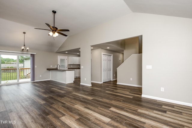 5 Loire Ct, Johnson City, TN 37604 - unfurnished living room featuring vaulted ceiling, a ceiling fan, a chandelier, dark wood-style floors, and baseboards