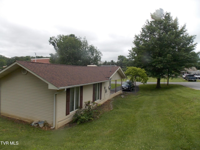 167 Cherry Ln, Bristol, VA 24201 - view of property exterior featuring roof with shingles, a yard, and a detached carport