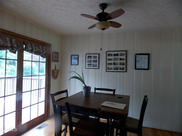 167 Cherry Ln, Bristol, VA 24201 - dining room featuring healthy amount of natural light, ceiling fan, a decorative wall, a textured ceiling, and french doors