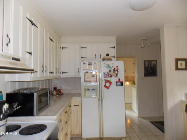 167 Cherry Ln, Bristol, VA 24201 - kitchen with white appliances, tile counters, under cabinet range hood, backsplash, and light tile patterned flooring