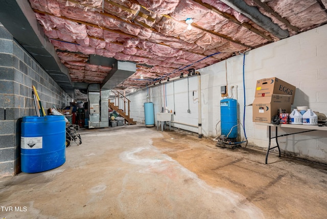 293 Miller Rd, Jonesborough, TN 37659 - unfinished below grade area featuring a water pressure tank, heating unit, concrete block wall, stairs, and a sink