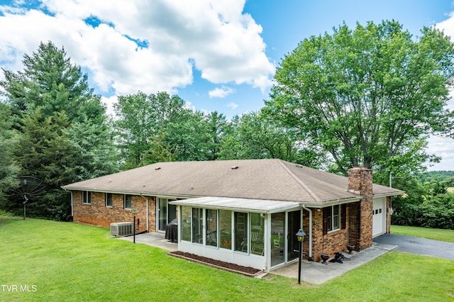 293 Miller Rd, Jonesborough, TN 37659 - back of property featuring a chimney, driveway, an attached garage, a sunroom, and a yard