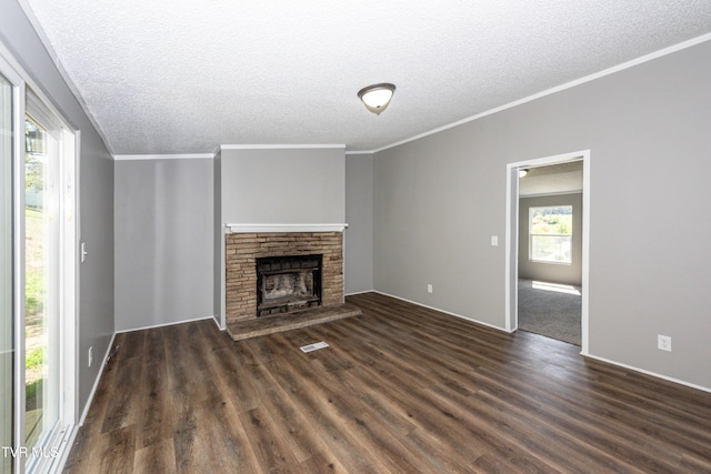 123 Griffin Dr, Dandridge, TN 37725 - unfurnished living room featuring a textured ceiling, dark wood-type flooring, ornamental molding, a fireplace with raised hearth, and baseboards