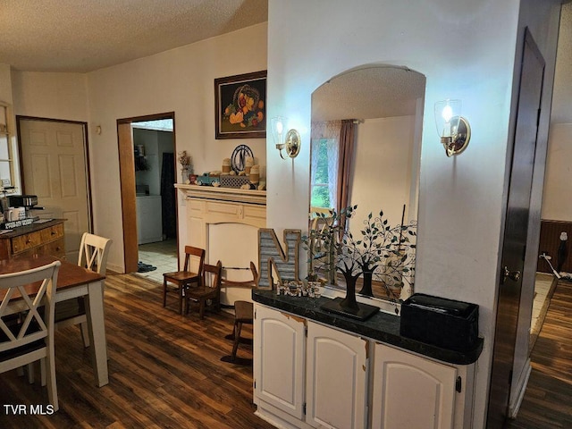 17508 Dreamers Ln, Glade Spring, VA 24340 - dining space featuring dark wood-style floors, arched walkways, and a textured ceiling