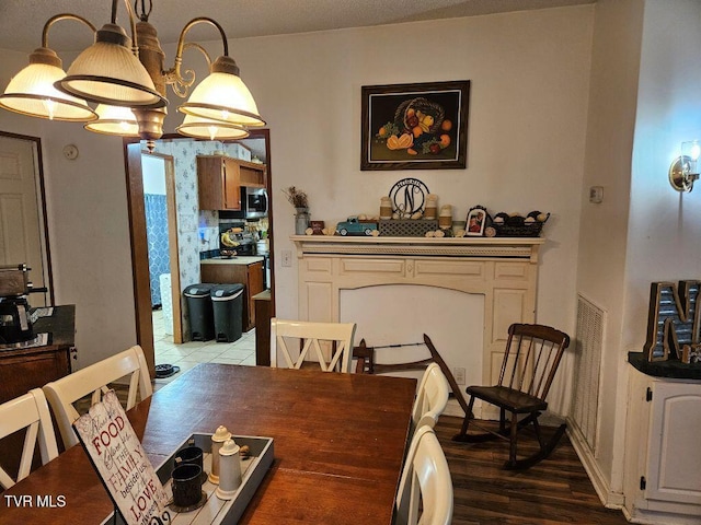17508 Dreamers Ln, Glade Spring, VA 24340 - dining space with light wood-style floors and a chandelier