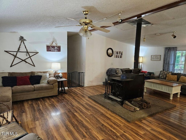 17508 Dreamers Ln, Glade Spring, VA 24340 - living room with wood finished floors, a wood stove, ceiling fan, and a textured ceiling