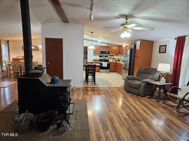 17508 Dreamers Ln, Glade Spring, VA 24340 - living area featuring light wood-style flooring, a ceiling fan, a textured ceiling, and lofted ceiling