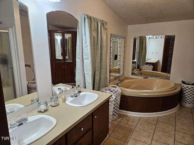 17508 Dreamers Ln, Glade Spring, VA 24340 - bathroom featuring a textured ceiling, a shower stall, a garden tub, toilet, and tile patterned flooring