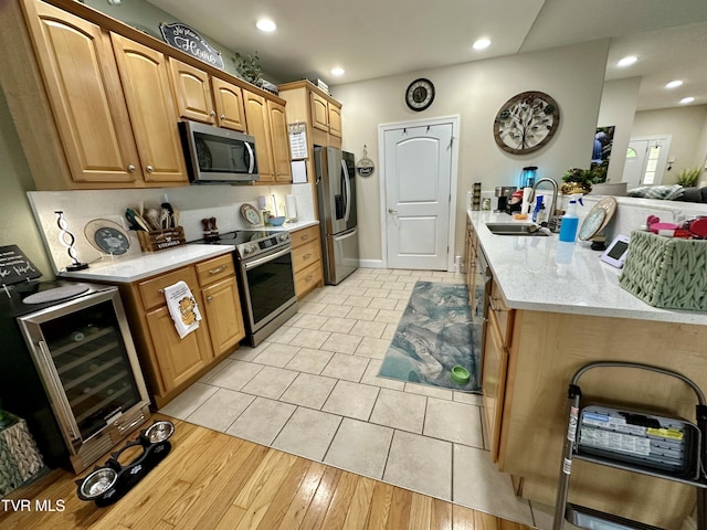 59 Whisper Bnd Unit 0, Johnson City, TN 37604 - kitchen with appliances with stainless steel finishes, wine cooler, a sink, a peninsula, and recessed lighting