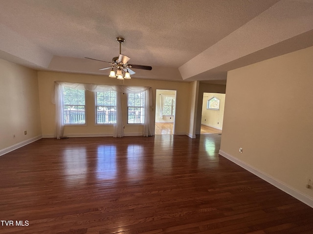 115 Butterfly Ct, Limestone, TN 37681 - empty room featuring a textured ceiling, dark wood-style flooring, ceiling fan, baseboards, and a raised ceiling