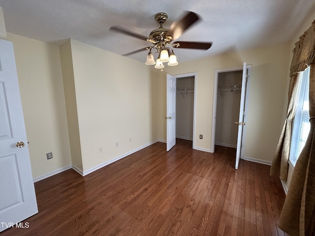115 Butterfly Ct, Limestone, TN 37681 - unfurnished bedroom featuring multiple closets, wood finished floors, baseboards, and a ceiling fan