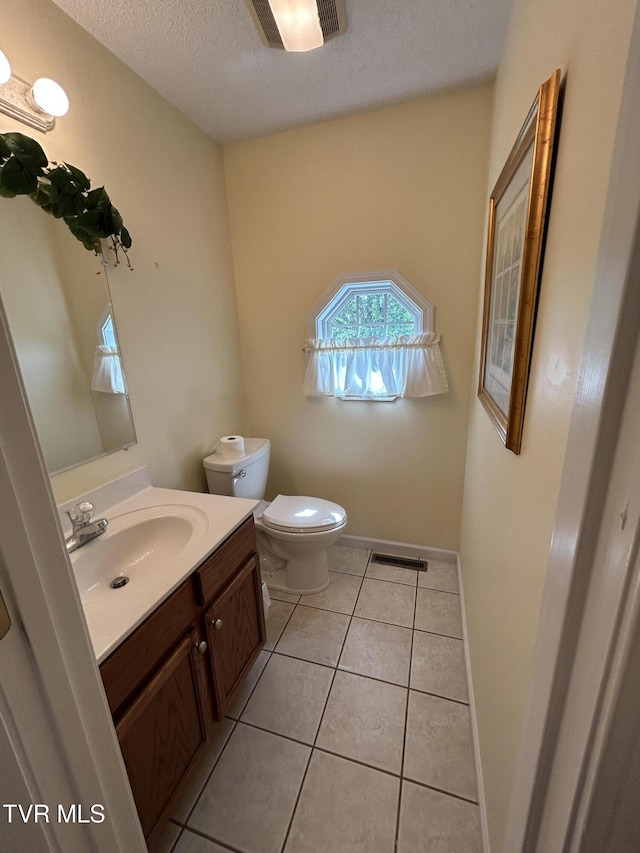 115 Butterfly Ct, Limestone, TN 37681 - bathroom with a textured ceiling, toilet, vanity, tile patterned flooring, and baseboards