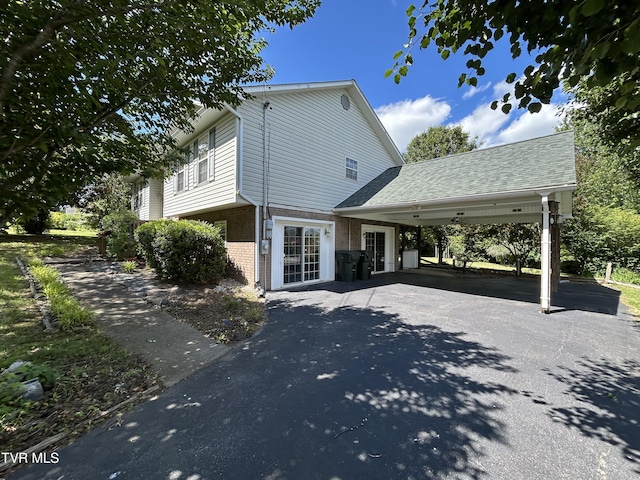 115 Butterfly Ct, Limestone, TN 37681 - back of property featuring brick siding, driveway, a carport, and a patio area