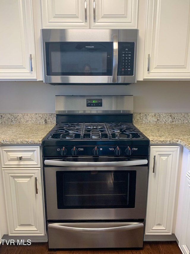 361 Belmont Dr Unit 14, Bristol, TN 37620 - kitchen featuring stainless steel appliances, white cabinetry, and light stone counters