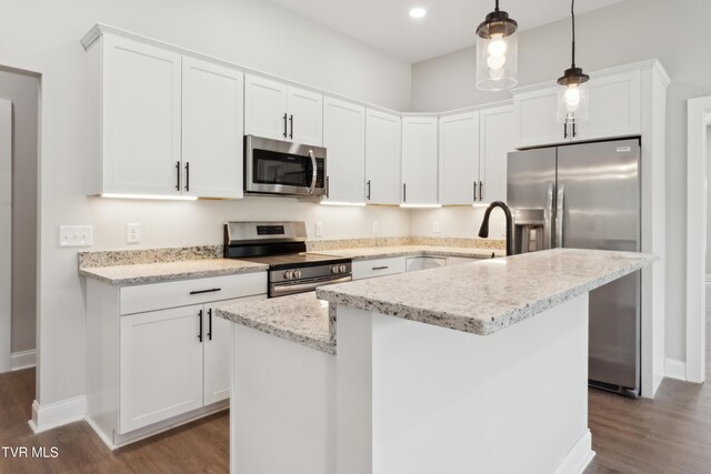 833 Granby Rd, Kingsport, TN 37660 - kitchen with stainless steel appliances, dark wood-style floors, white cabinets, baseboards, and a center island