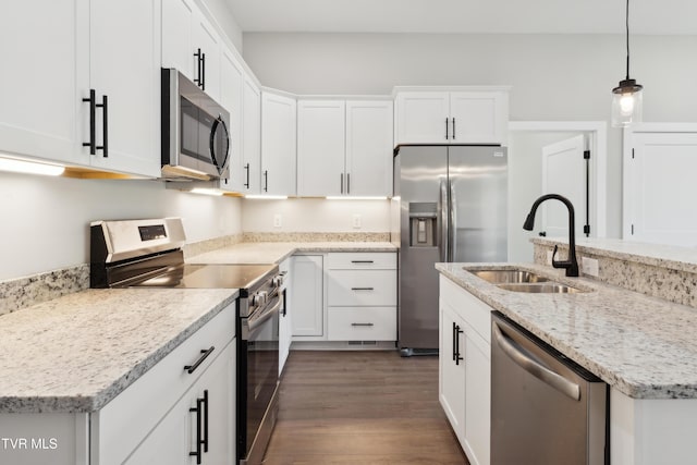 833 Granby Rd, Kingsport, TN 37660 - kitchen with stainless steel appliances, a sink, dark wood-type flooring, white cabinets, and decorative light fixtures