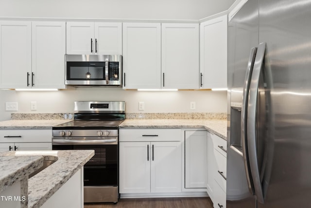 833 Granby Rd, Kingsport, TN 37660 - kitchen featuring stainless steel appliances, white cabinetry, and light stone counters