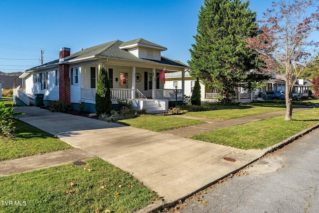 215 Clinchfield Ave, Erwin, TN 37650 - view of front of property with a porch, a front lawn, a chimney, and a shingled roof